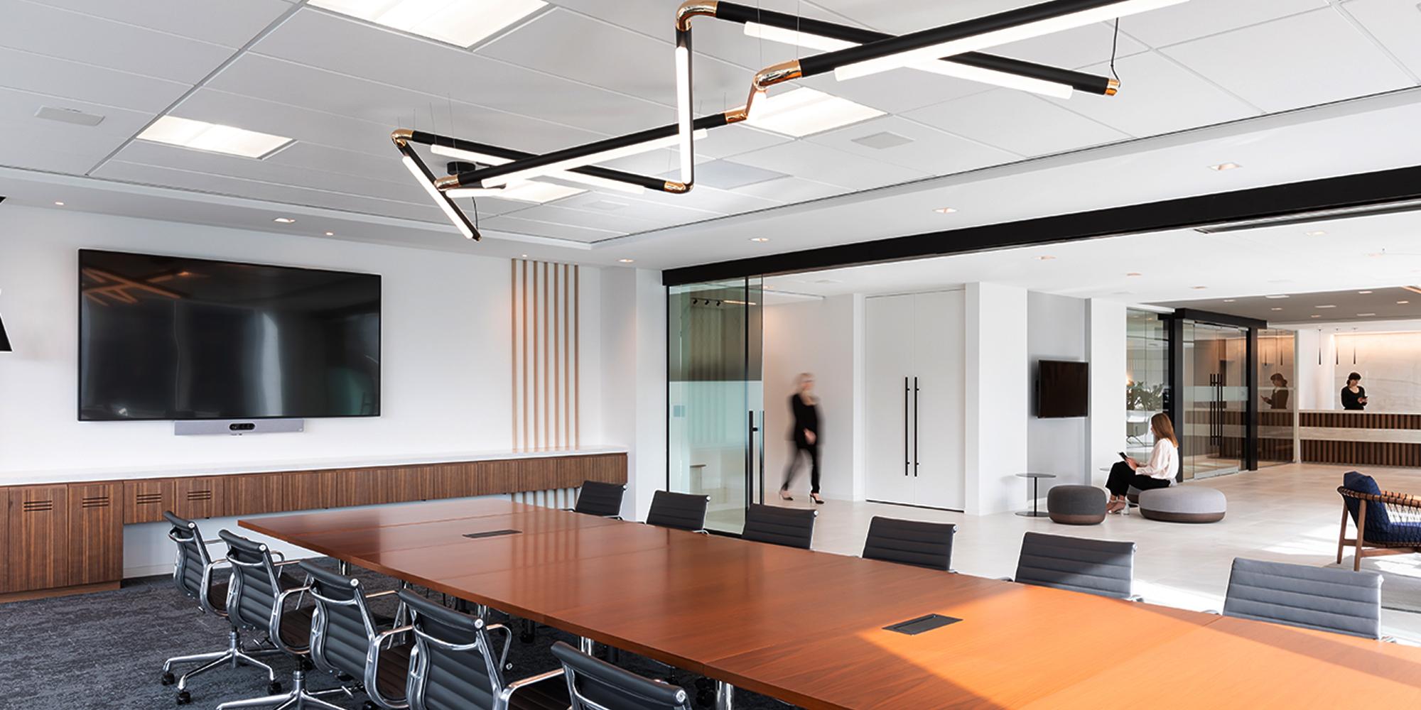 Meeting room with long conference table surrounded by chairs